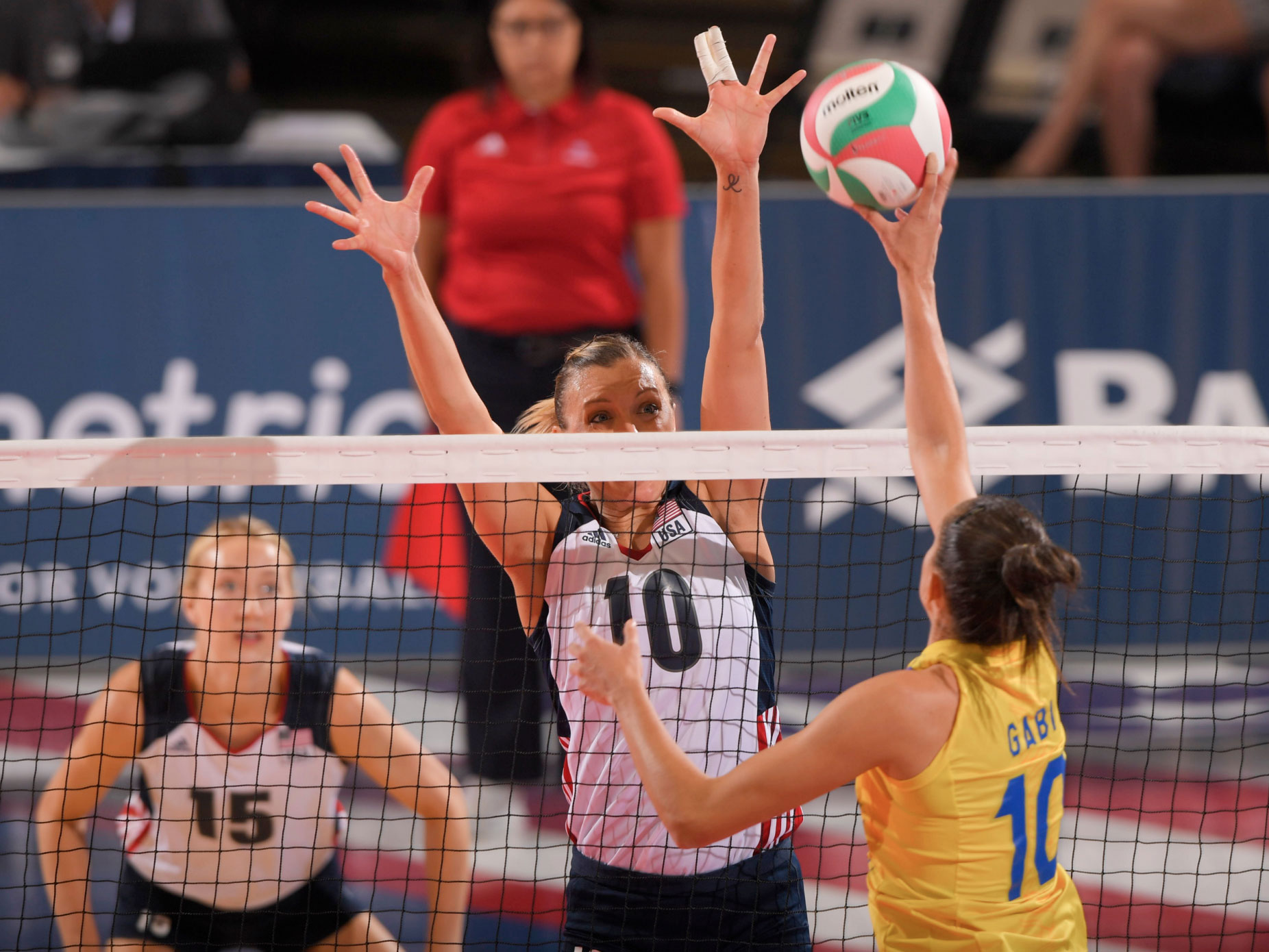 volleyball player jordan larson blocking at net