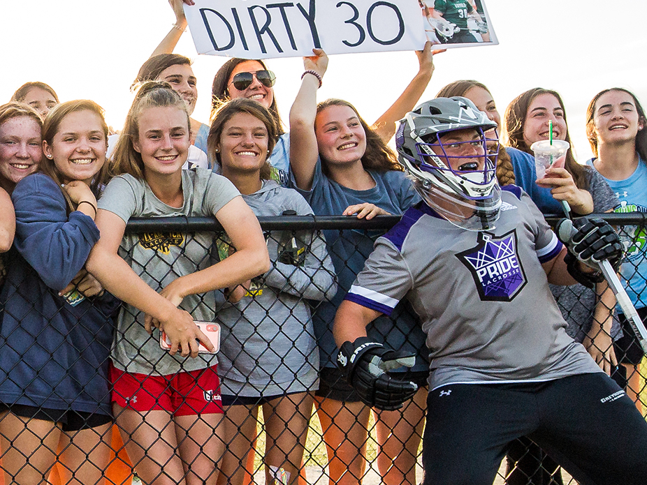 Molly Wolf poses with fans on the sideline.