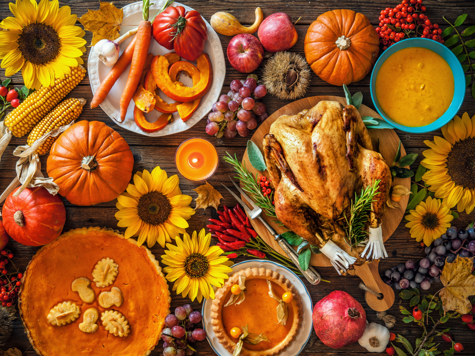 Thanksgiving Table with pie, turkey, and pumpkins.