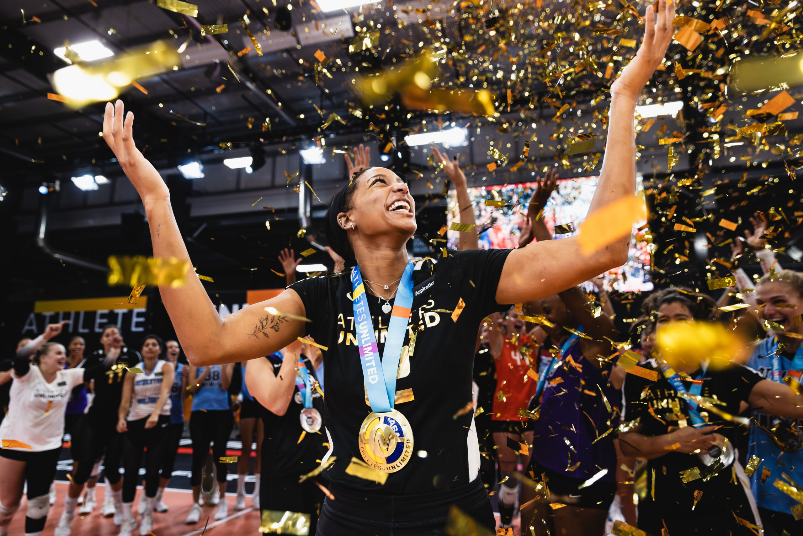Leah Edmond celebrates her championship surrounded by gold confetti.