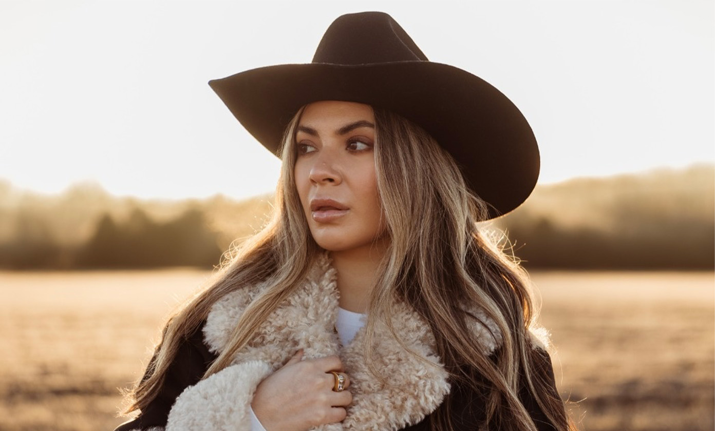 Andrea Vasquez in cowboy hat and fur lined coat